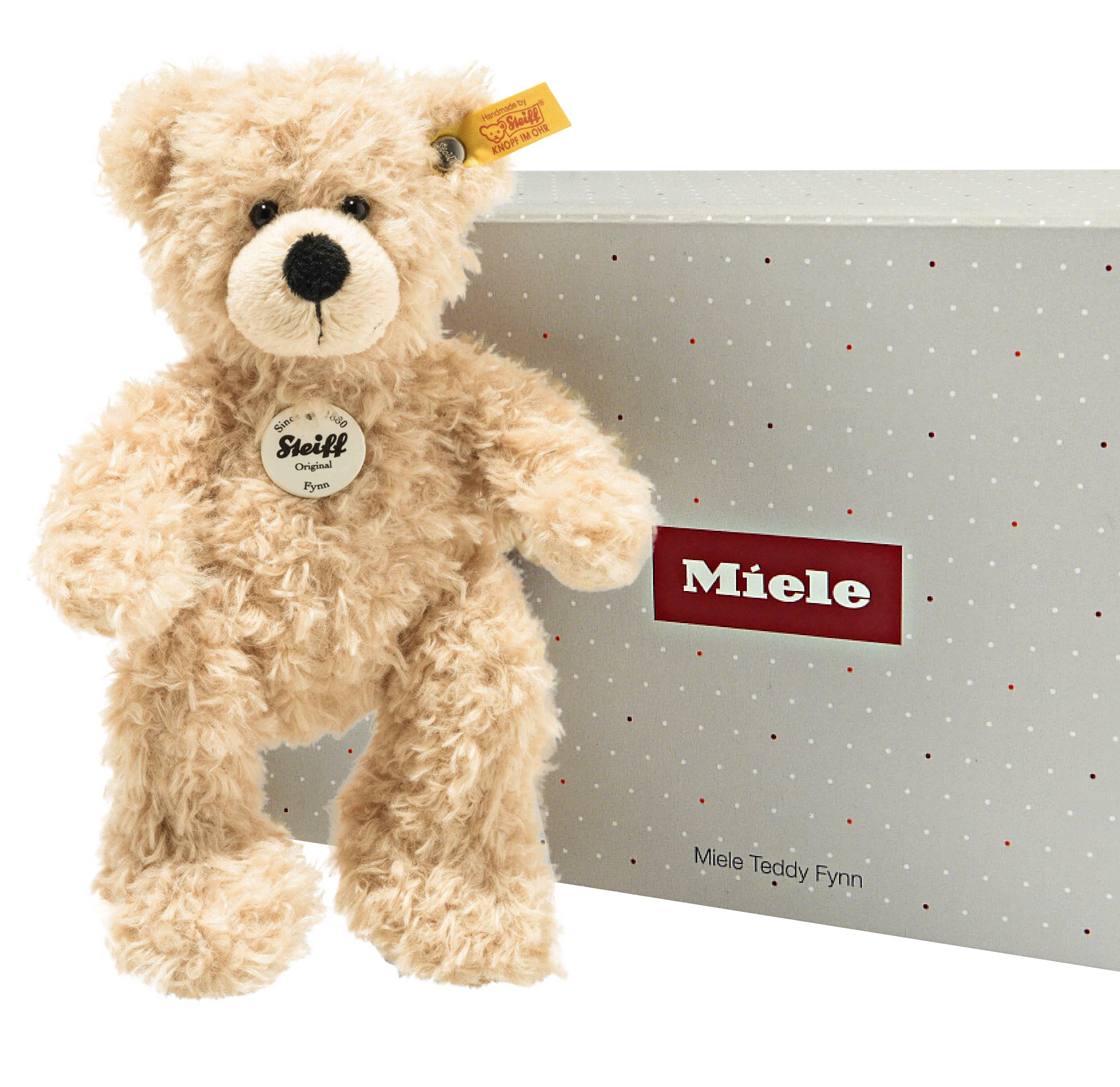 Plüschtier Teddy mit einer Verpackungsbox und dem Logo von Miele
